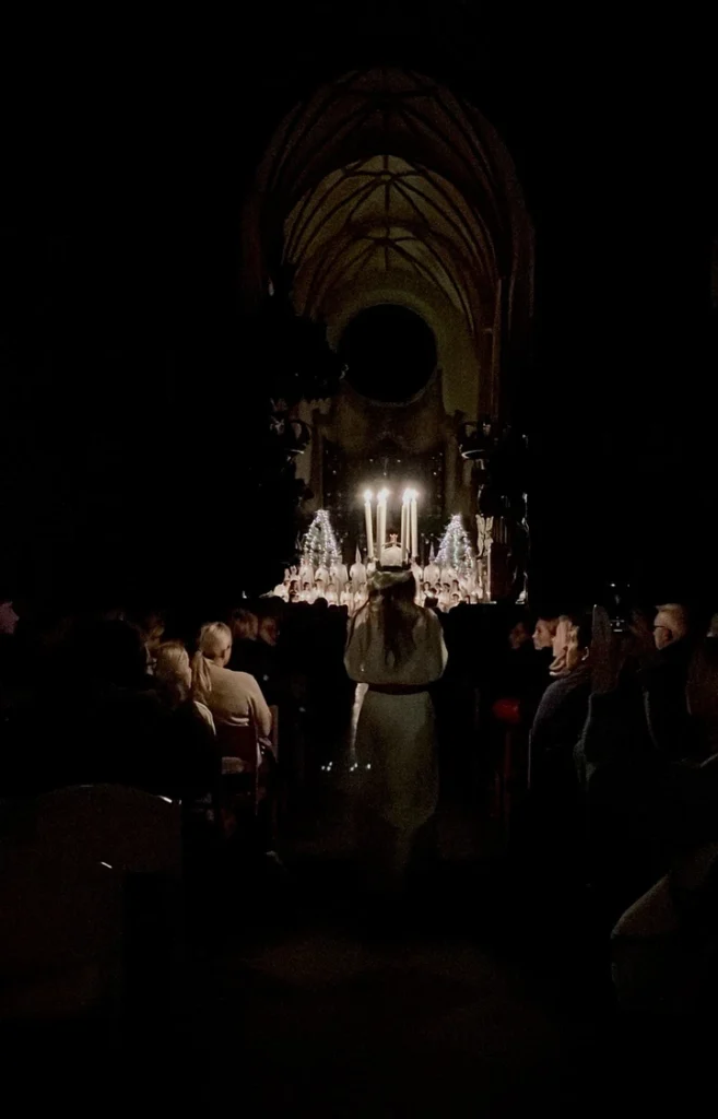 Lucia bride dressed white wearing candle crown