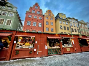 Winter market in Stockholm Old Town with red stalls before colourful houses