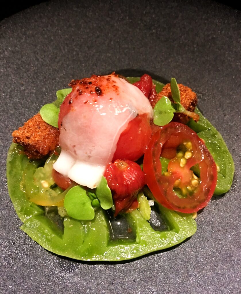Fine dining dish with green and red tomatoes