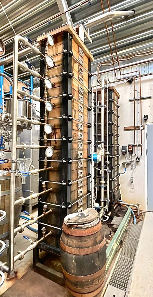 A tall and narrow wooden still for spirit manufacturing.