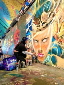 Graffiti artist at work on a female face