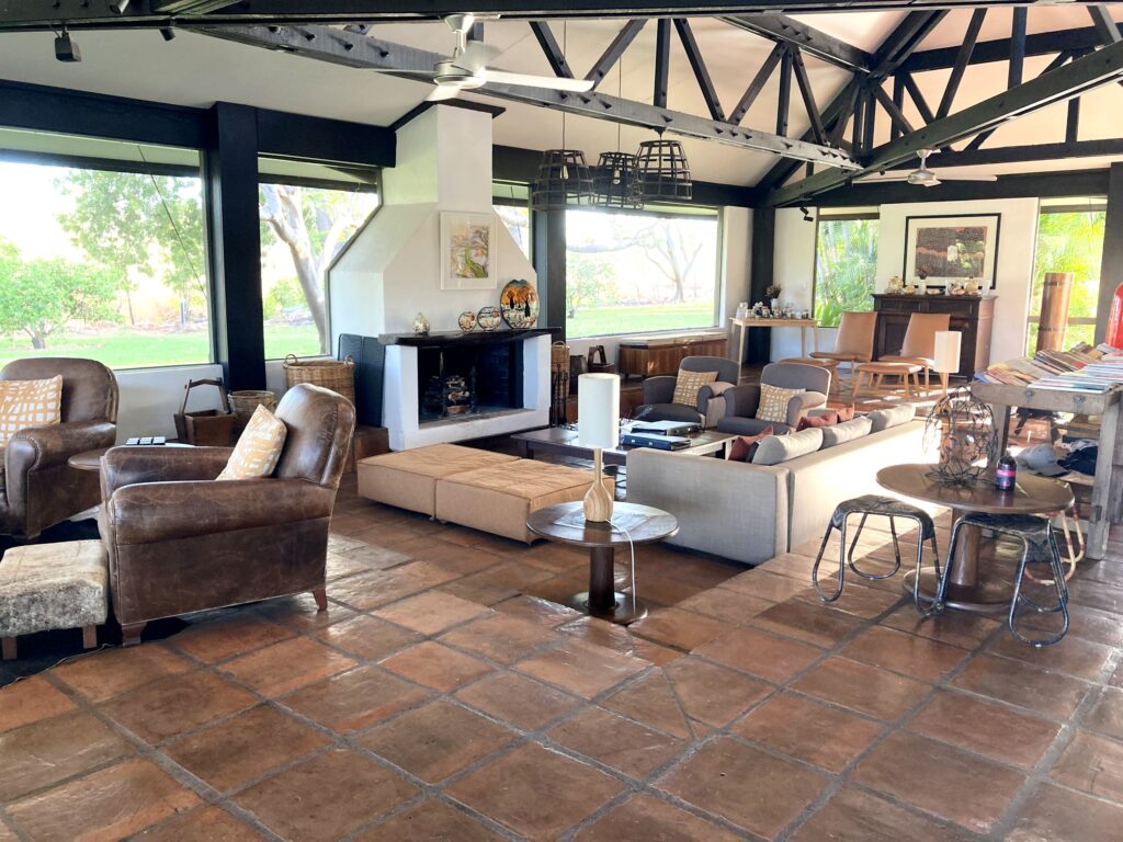 Loung area on tile floors with fireplace and seating arrangements.