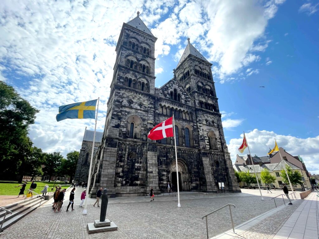 Stone facade cathedral in Lund with twin towers.