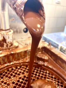 Chocolate pouring out from tap.