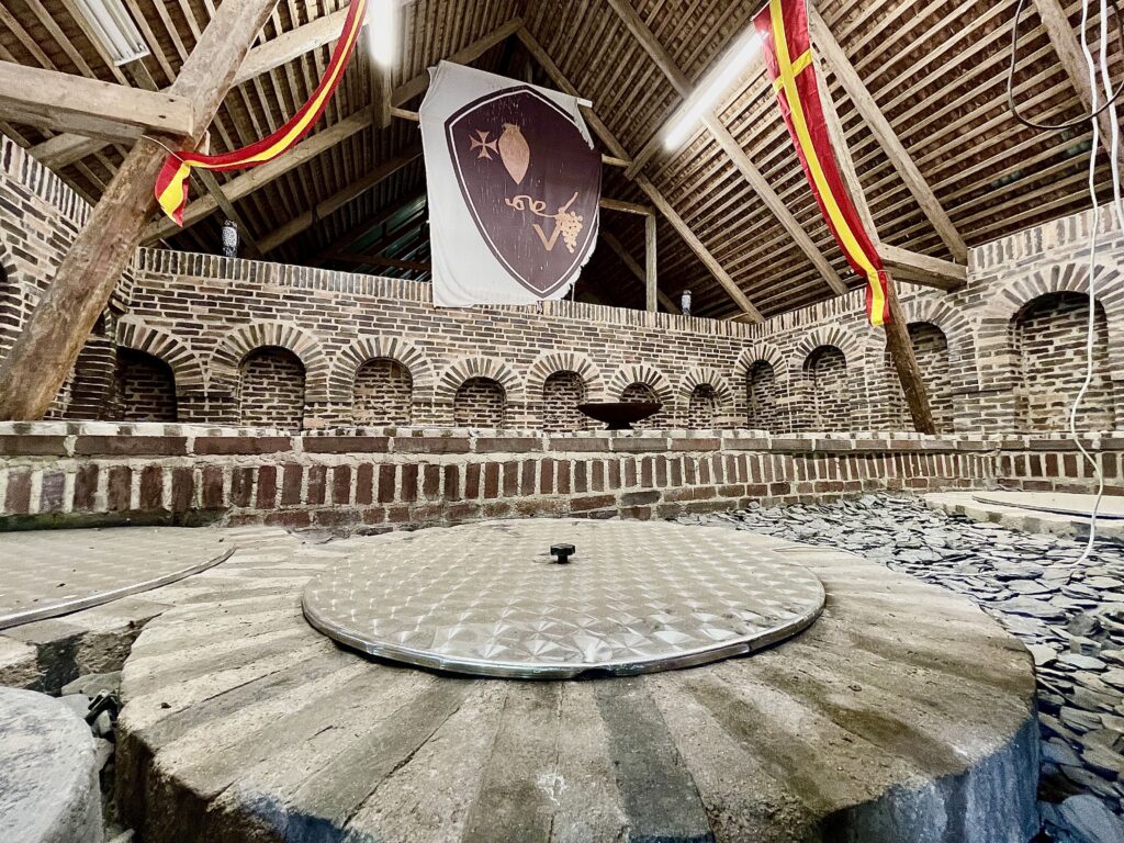 Large amphoras dug into the ground in a large building