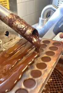 Chocolate poured into praline forms