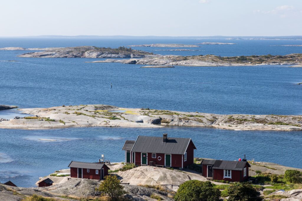 Island in an archipelago with small red houses on island in foreground