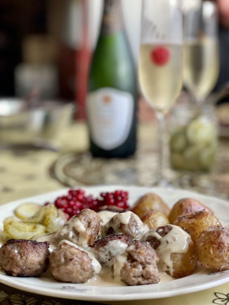 Plate with Swedish meatballs, lingonberry, and potatoes.