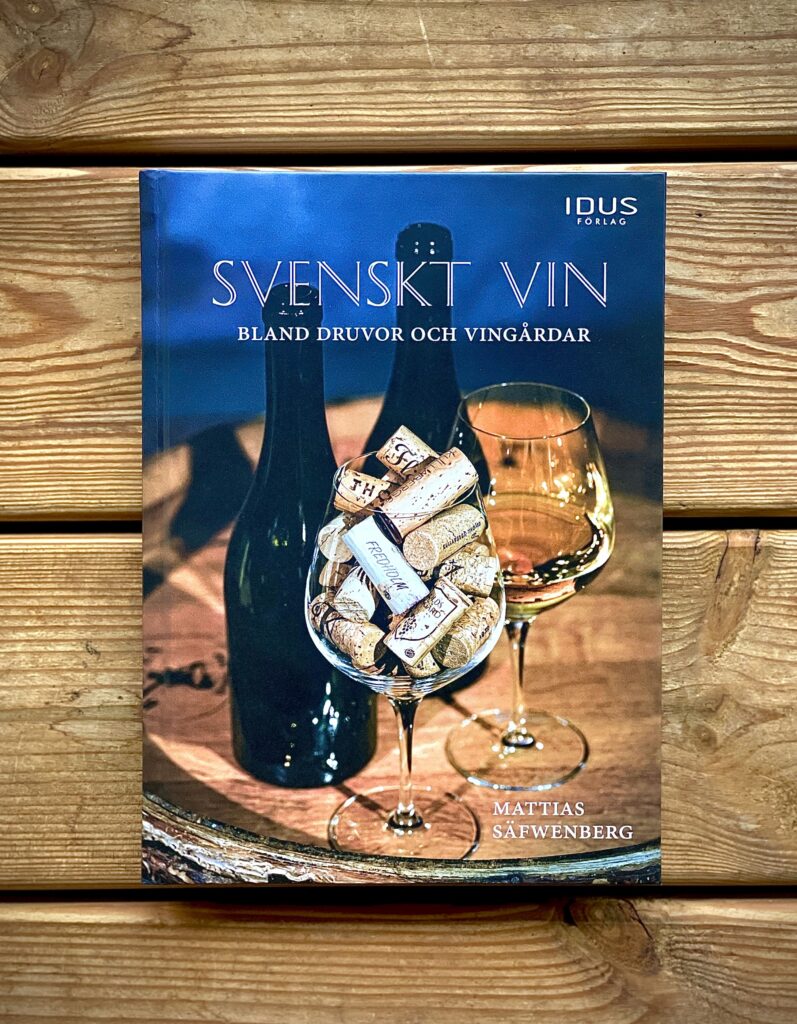 A book about Swedish Wine lying on a wooden table.
