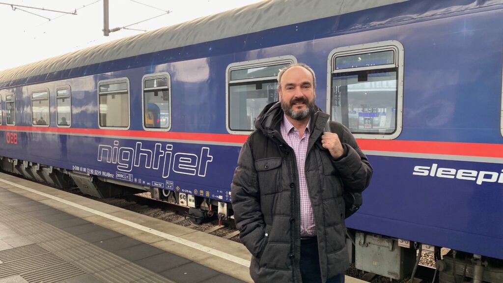 Mark Smith of Seat61 in front of a sleeper train.