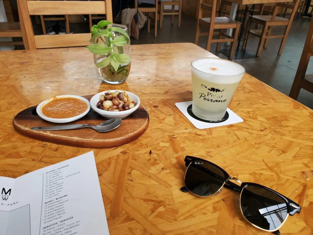 A table with a drink, sunglasses, and a menu