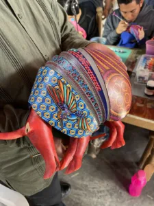 Hand painted woodcrafts representing zoomorphic creatures.