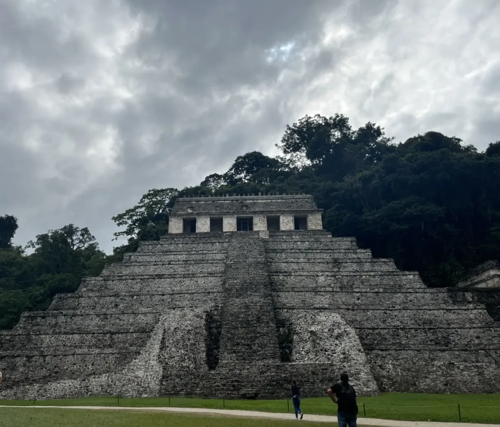 Stepped pyramid of stone with cloudy sky above