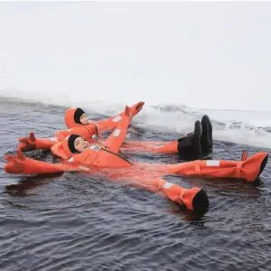 Two people in orange survival suits lying in icy waters.