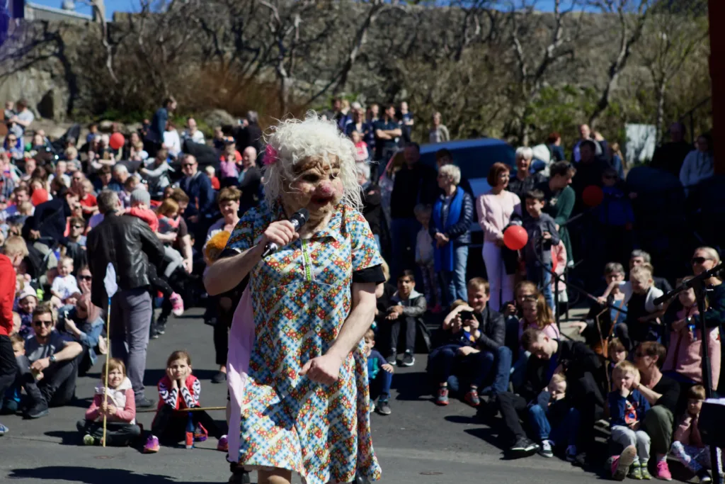 Costumed entertainer with troll face at a festival