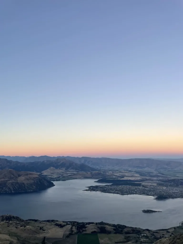 Sun setting over a vista of lakes and mountains