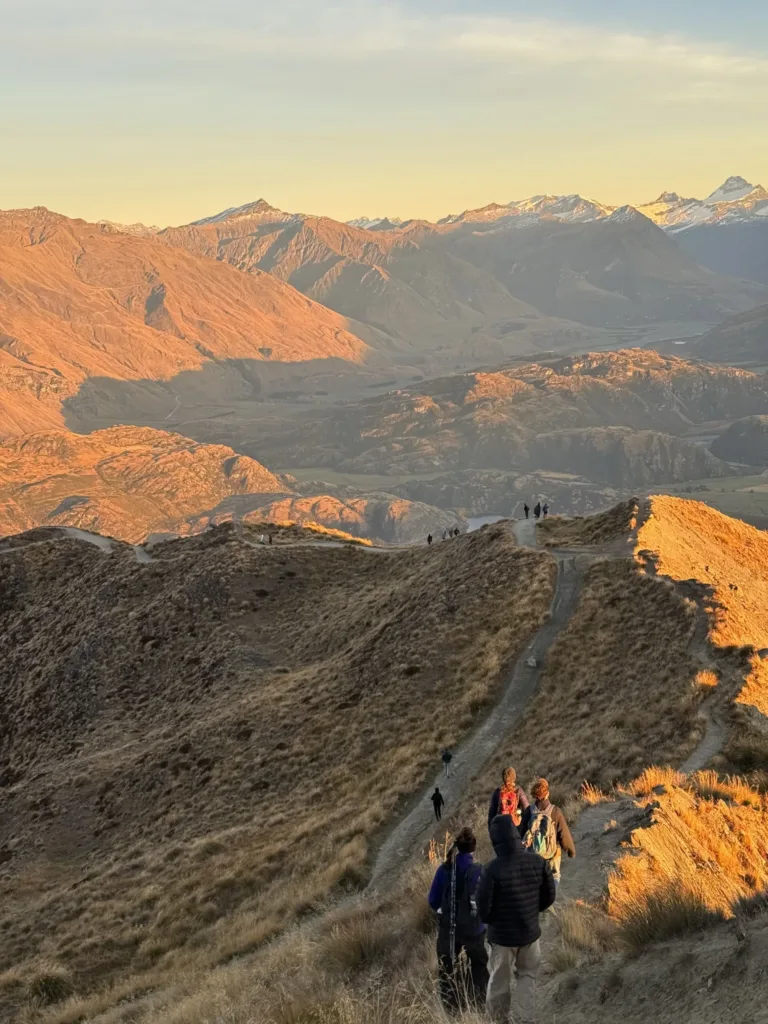 Hiking track with on mountain ridge with groups of people.