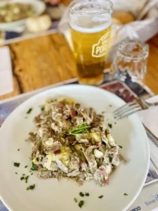 Plate of food and glass of beer.
