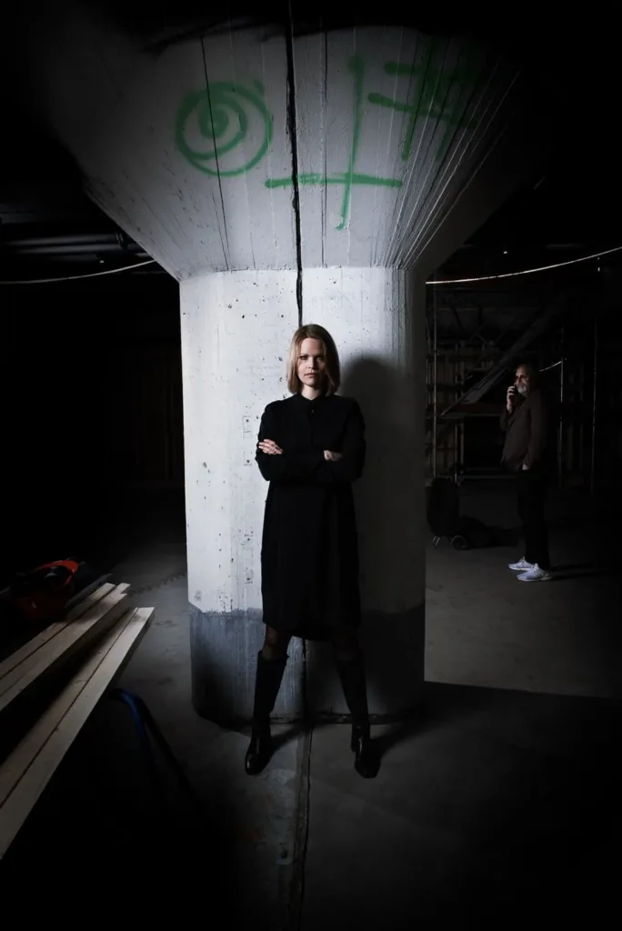 Woman and man posing in  venue under construction