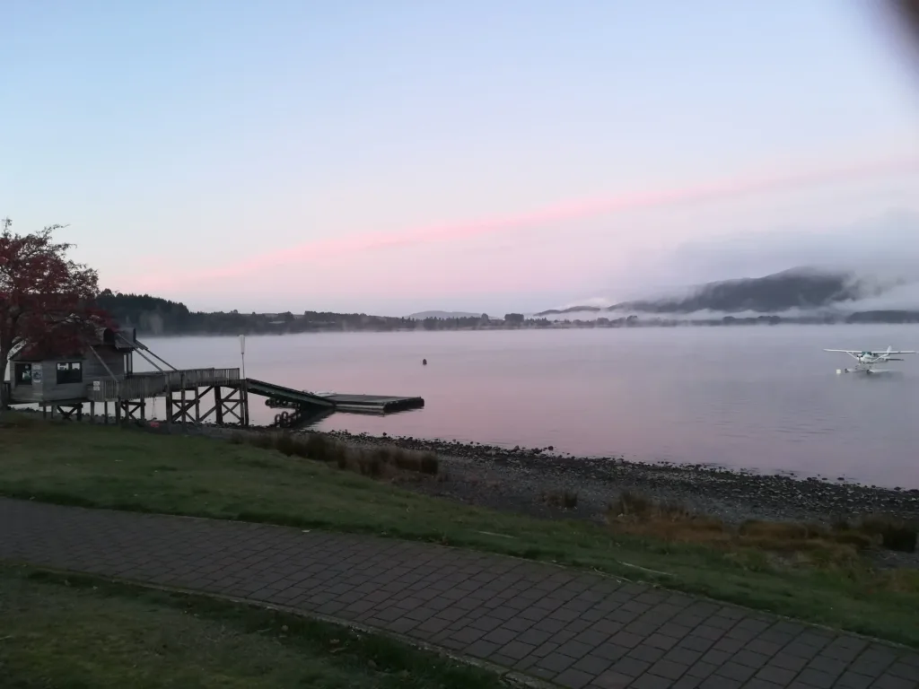 Lake with a sea plane parked near the shore