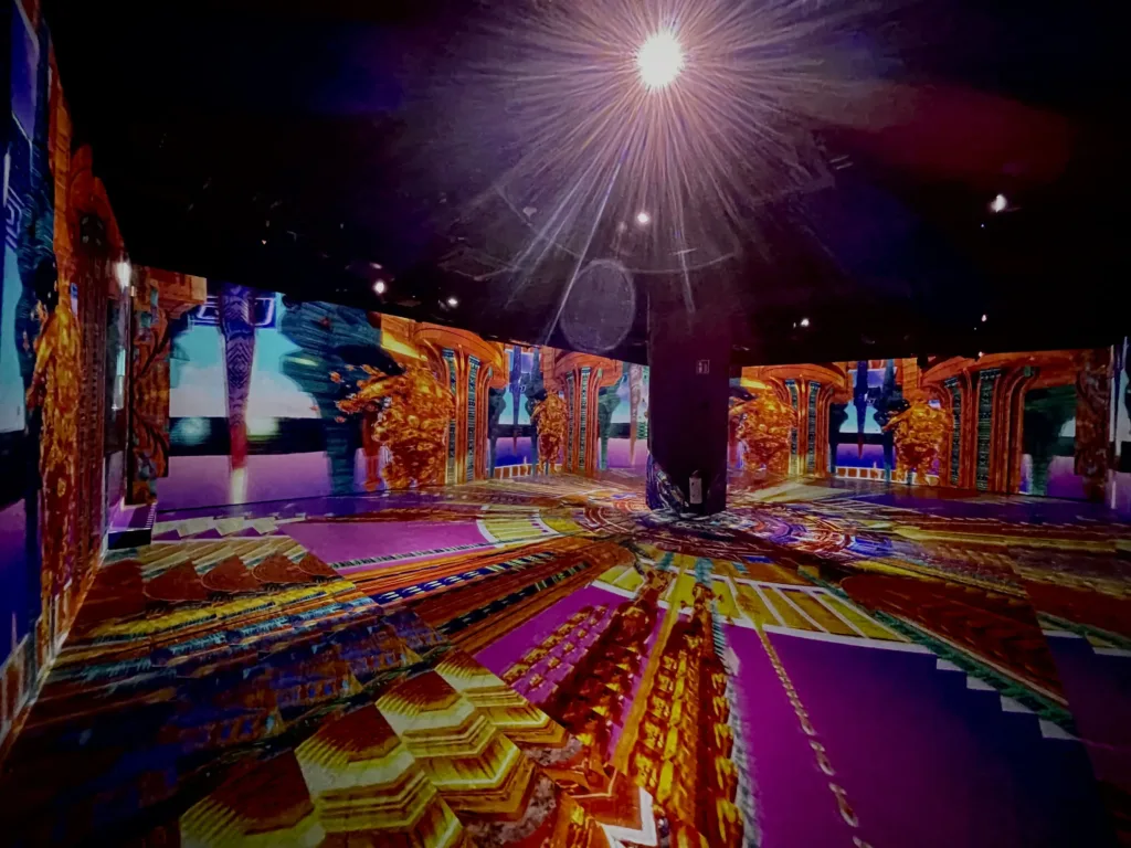 Kaleidoscopic colours and patterns projected on walls.