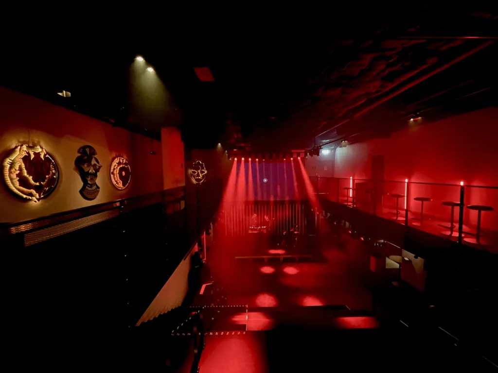 Cultural venue bathing in dark red light.