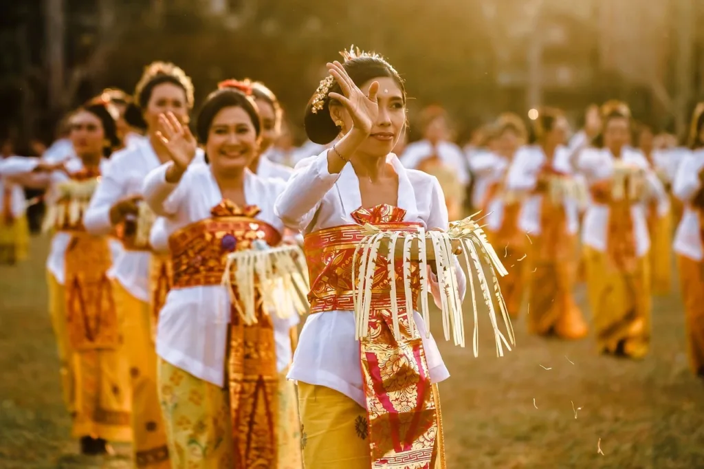 Women dancing in group in orange and white outfits