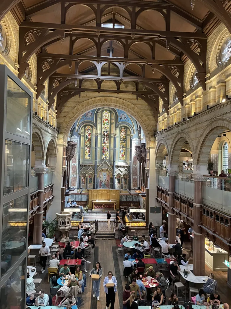 Inside of a church fitted with food stalls and tables