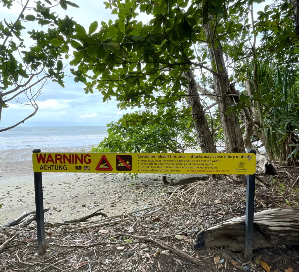 Warning sign for crocodiles on a beach
