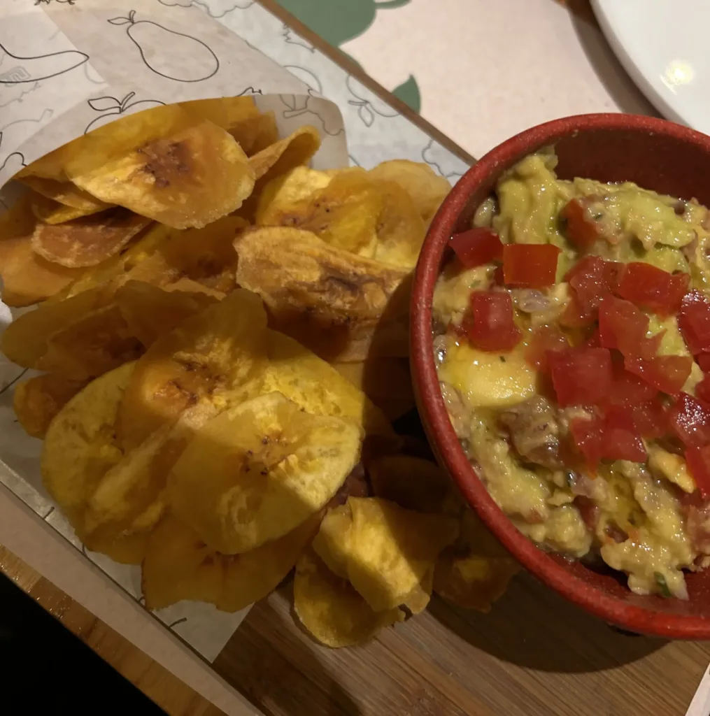Plantain chips and bowl of guacamole.