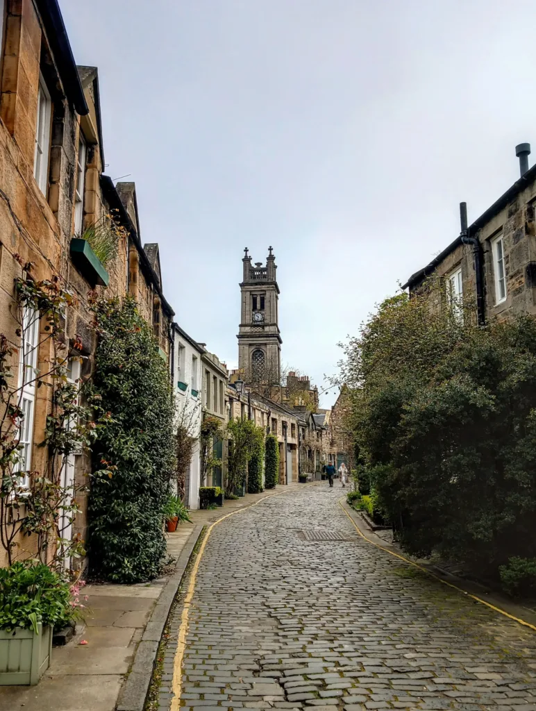 Small street with a church tower amid the buildings.