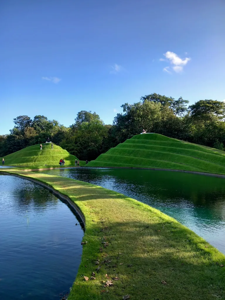 Grassy walkways and hills between ponds of water