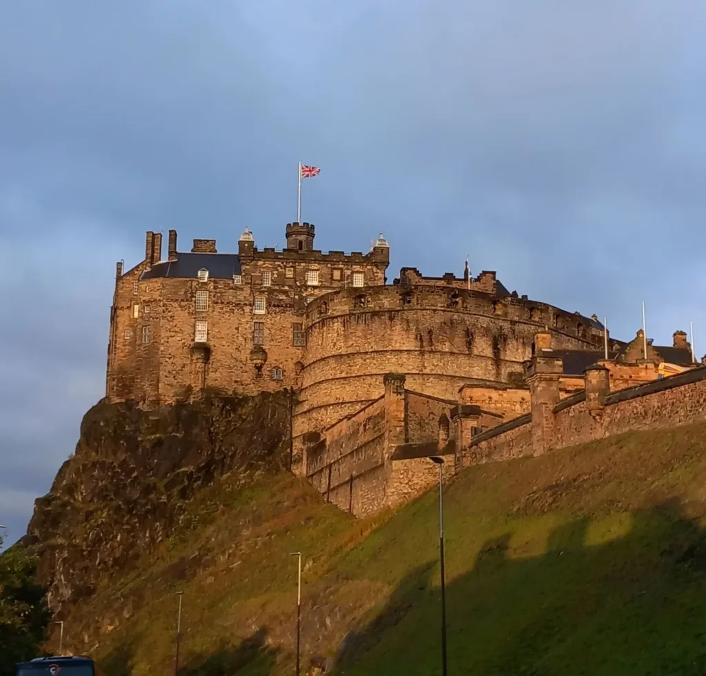 Castle perched on a hill with English flag