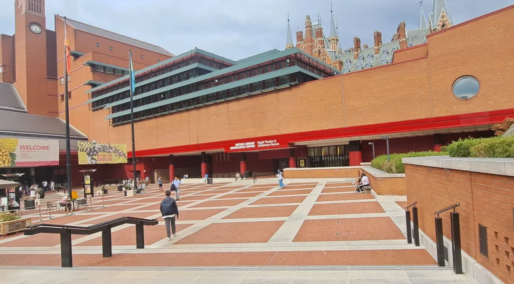 Large multistory red brick building with large open space in front