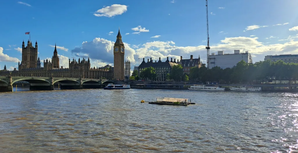 River view of a clock tower and palace