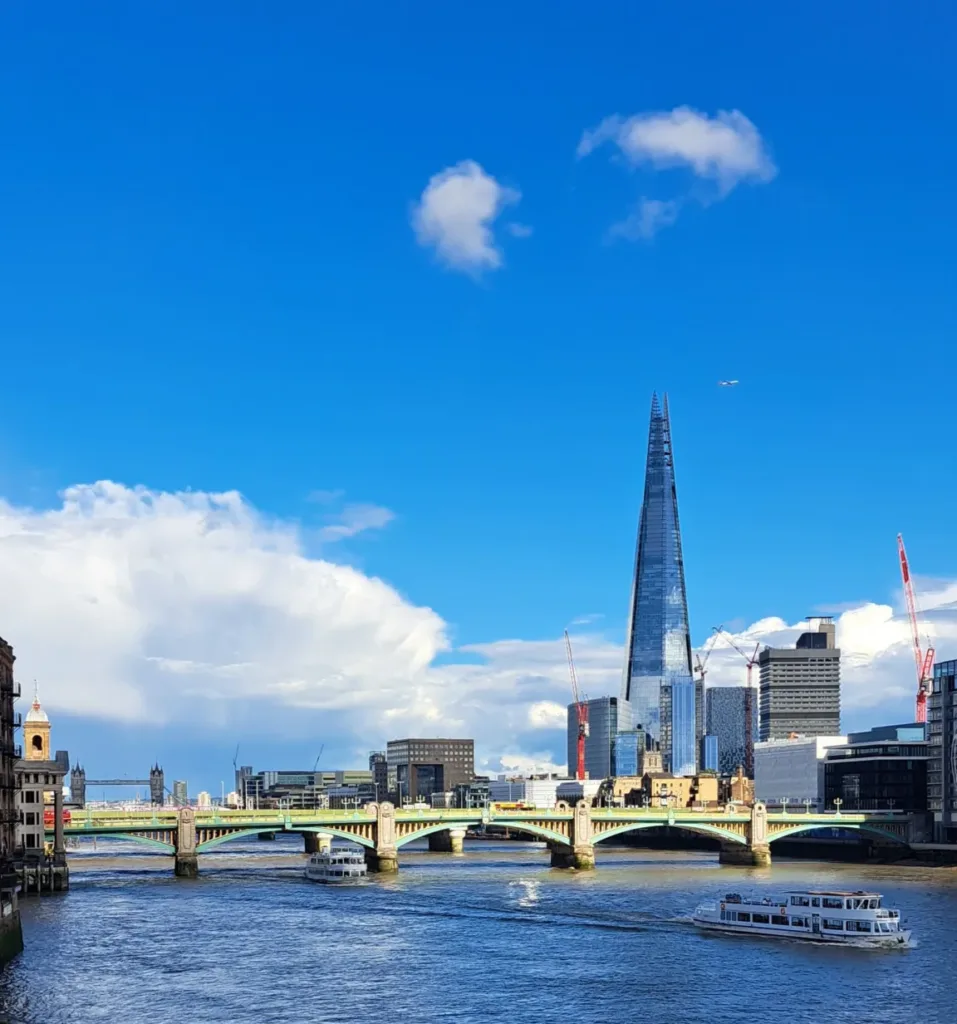 River and bridge in front of a skyscraper