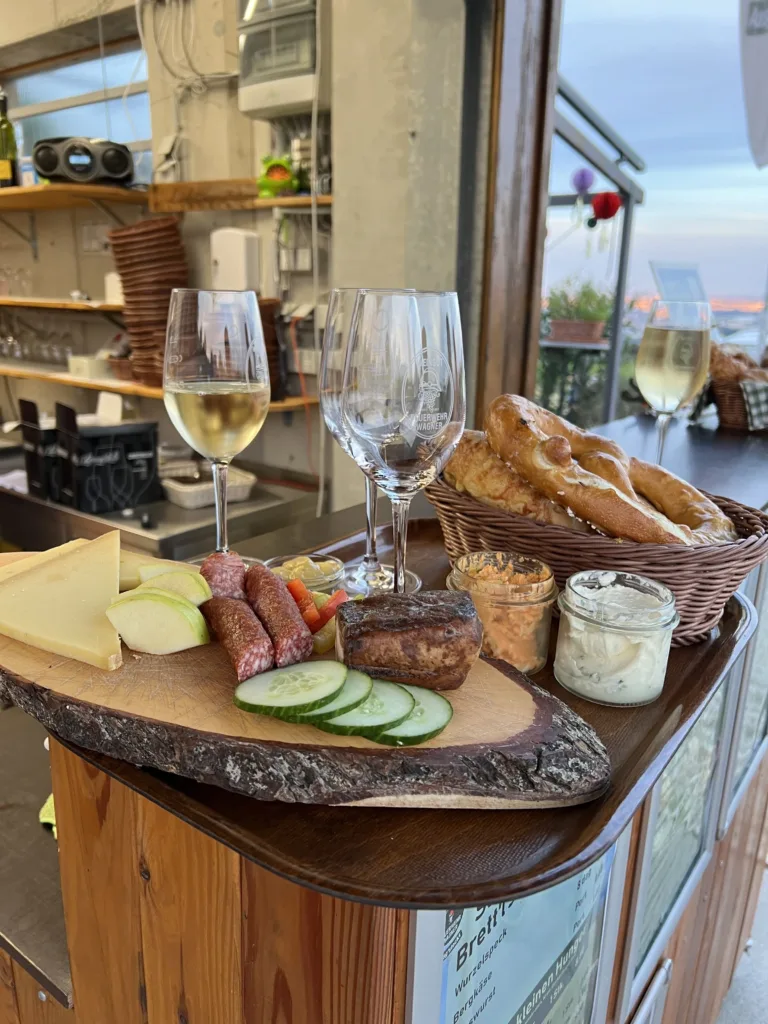 Platter of cheese, meat, bread, and wine