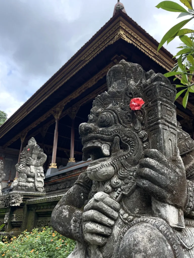 Two grey statues inside a temple