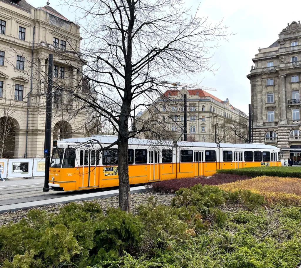 Yellow tram near palace buildings