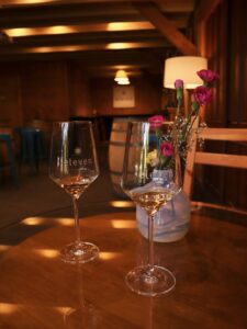 Two glasses of wine on a wooden table in a tasting room