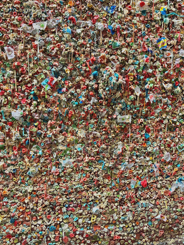A wall with old chewing gum covering it