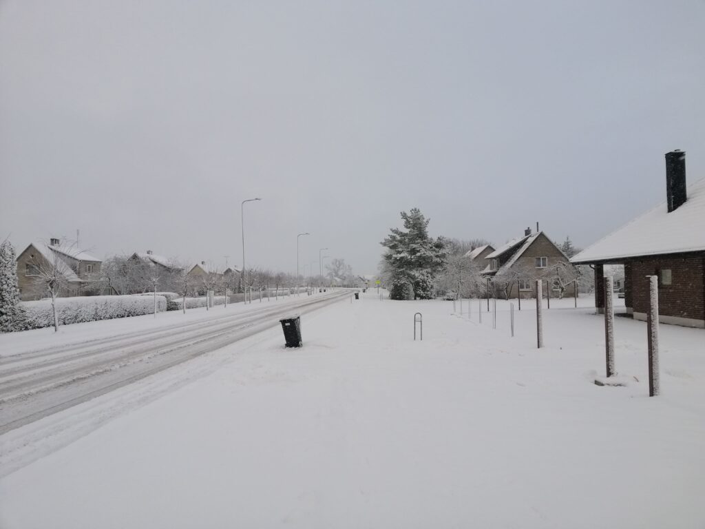 Street in residential area covered in snow