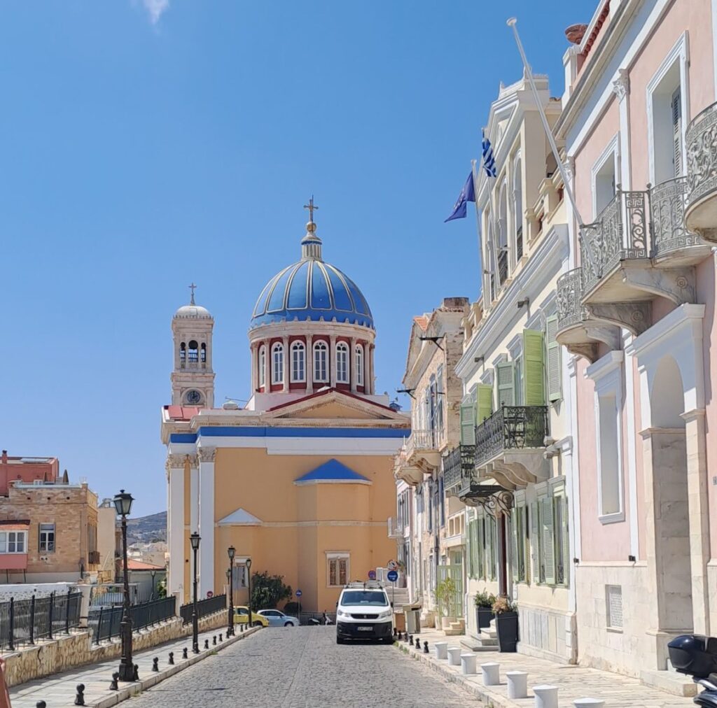 A blue domed church at the end of a street