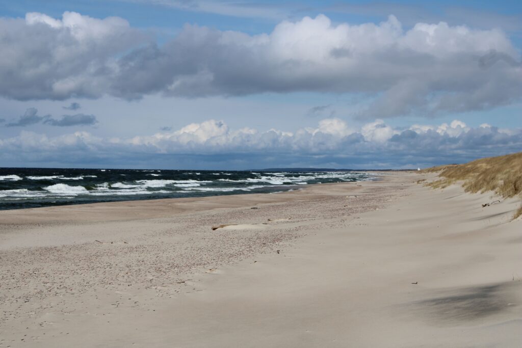 White sand beach with waves coming in.