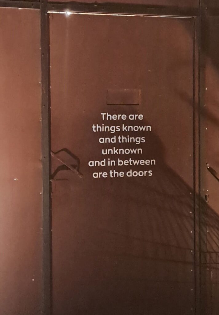 Brown door with text written on top of it.