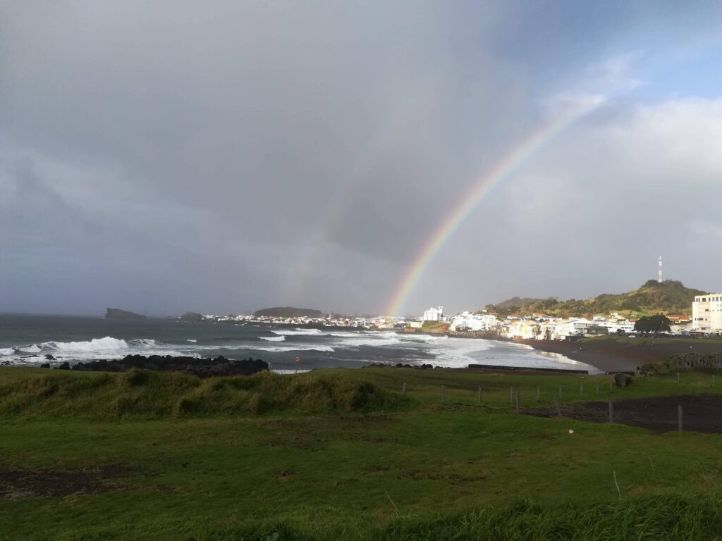Rainbow over beach and seaside village