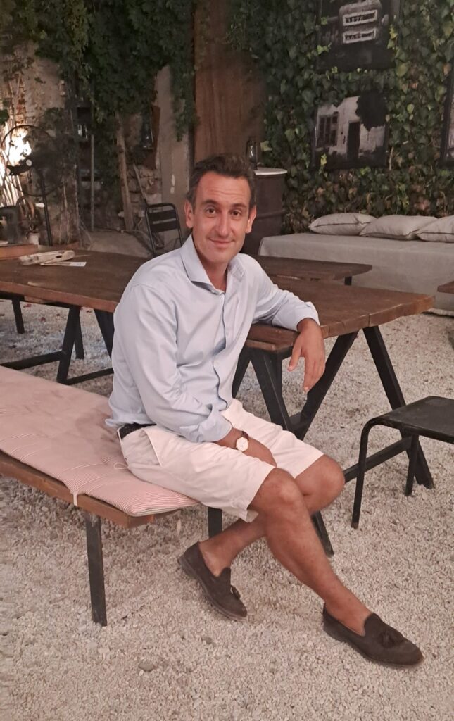 Man sitting on the edge of a communal table