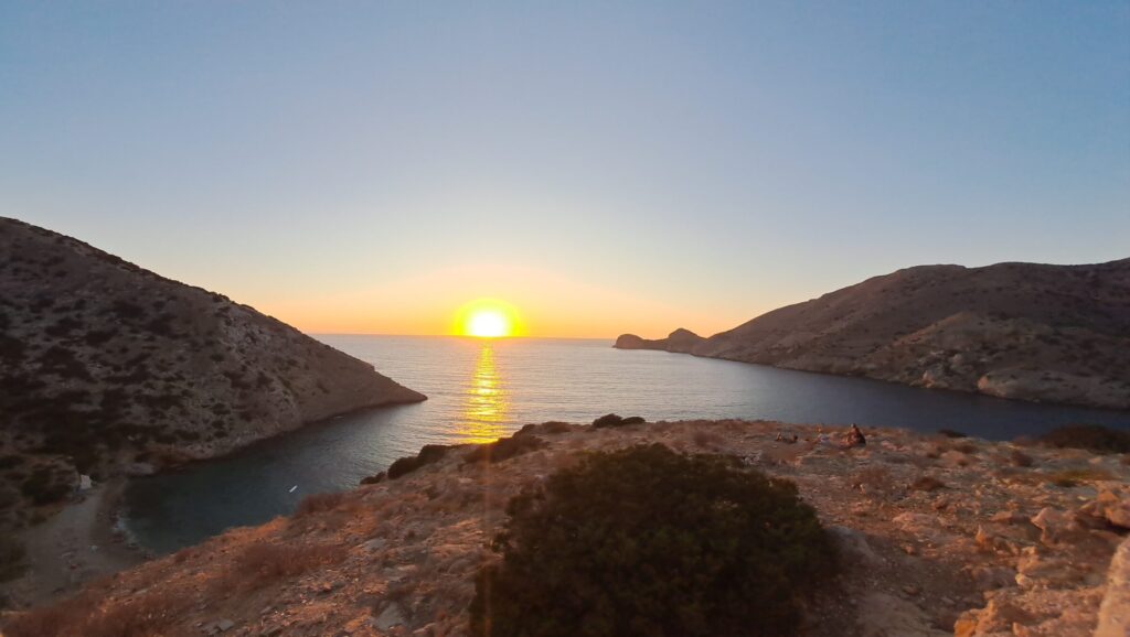 Sun setting in between two mountainsides.