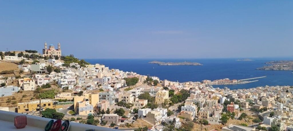 View of a harbour, islands, and white washed buildings from above