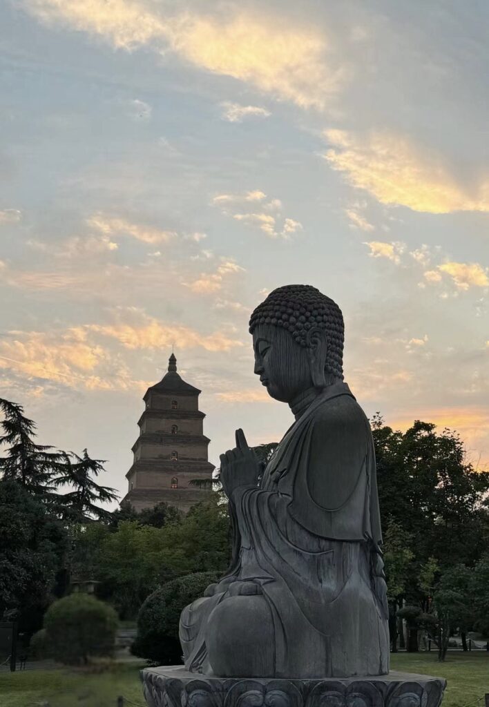 Statue with multistory pagoda in the background